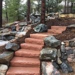 flagstone steps next to rock waterfall